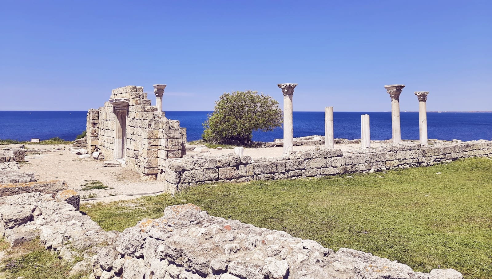 Ancient marble columns and ruins on Delos beside the sea